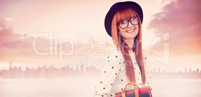 Composite image of smiling hipster woman holding book belt