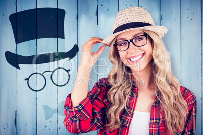 Composite image of gorgeous smiling blonde hipster posing