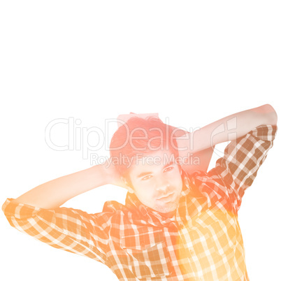 Composite image of hipster with hands behind head lying on hardw