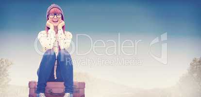 Composite image of smiling hipster woman sitting on suitcase