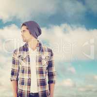 Composite image of confident hipster looking away while standing