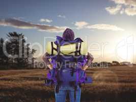 Composite image of rear view of a hipster woman with a travel ba