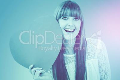 Composite image of smiling hipster woman with a big red heart