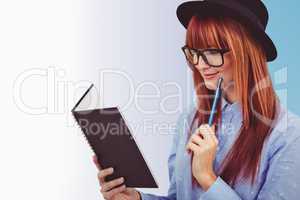 Composite image of smiling hipster woman writing notes