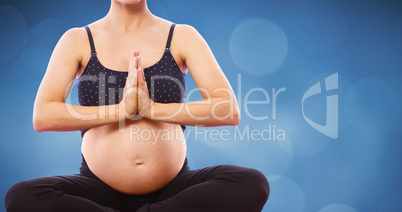 Composite image of pregnant woman sitting on exercise mat with h