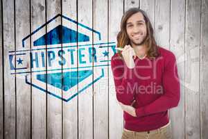 Composite image of portrait of happy hipster holding pen