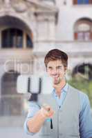 Composite image of businessman taking selfie in office