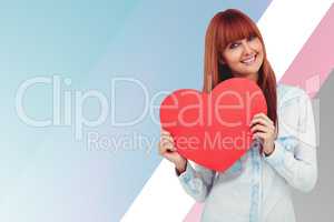Composite image of attractive hipster woman behind a red heart