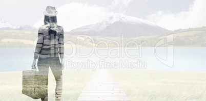 Composite image of rear view of a hipster woman holding suitcase