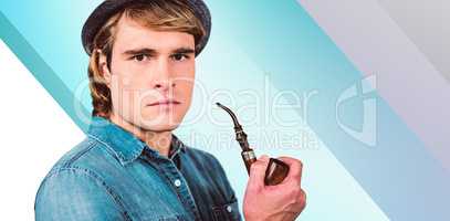 Composite image of serious hipster holding pipe
