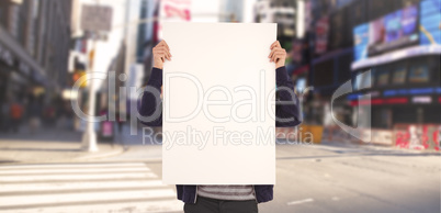 Composite image of man showing billboard in front of face