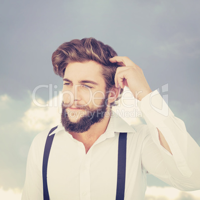 Composite image of hipster scratching head while thinking