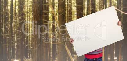 Composite image of hipster woman behind a big white card