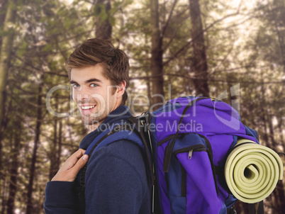 Composite image of side view of happy man with backpack