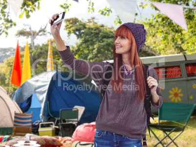 Composite image of smiling hipster woman taking selfie