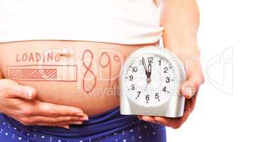 Composite image of pregnant woman showing clock and bump