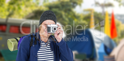 Composite image of backpacker hipster taking pictures with a ret