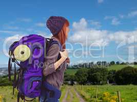 Composite image of side view of a hipster woman with a travel ba