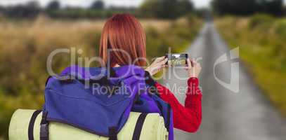 Composite image of smiling hipster woman with a travel bag