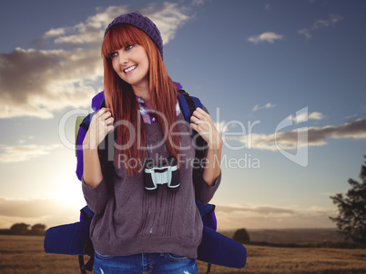 Composite image of smiling hipster woman with a travel bag