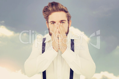 Composite image of portrait of hipster with hands covering mouth