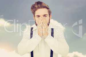 Composite image of portrait of hipster with hands covering mouth