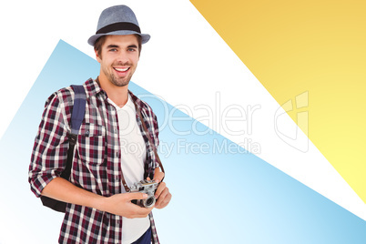 Composite image of portrait of man smiling while holding camera