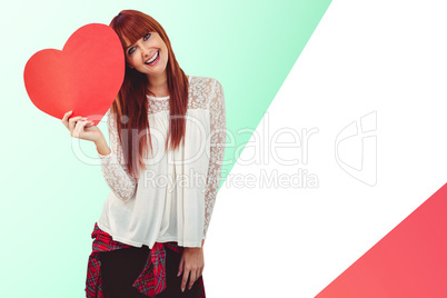 Composite image of smiling hipster woman with a big red heart