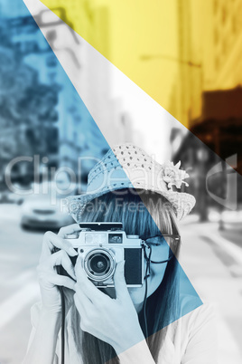 Composite image of portrait of a smiling hipster woman holding retro camera