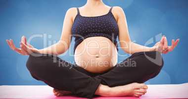 Composite image of pregnant woman sitting on mat in lotus pose