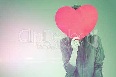 Composite image of hipster woman behind a red heart