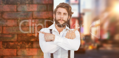 Composite image of confident hipster pointing sideways with arms