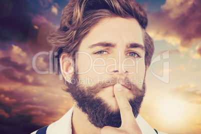 Composite image of portrait of hipster with finger on chin
