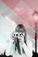 Composite image of attractive hipster photographing with camera
