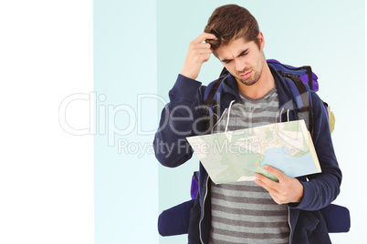 Composite image of man scratching head looking in map