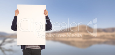 Composite image of man showing billboard in front of face