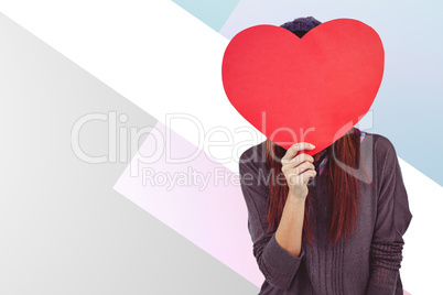 Composite image of hipster woman behind a red heart