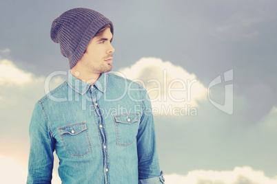 Composite image of confident hipster wearing knitted hat