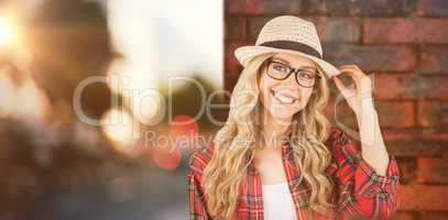 Composite image of gorgeous smiling blonde hipster posing