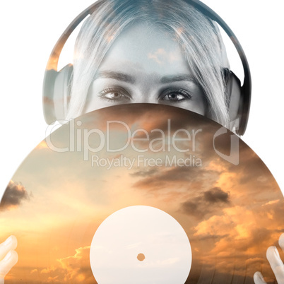 Composite image of portrait of a beautiful woman holding a vinyl