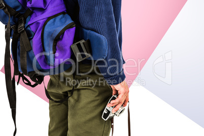 Composite image of midsection of backpacker hipster holding came
