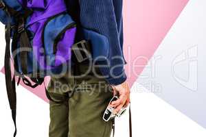 Composite image of midsection of backpacker hipster holding came