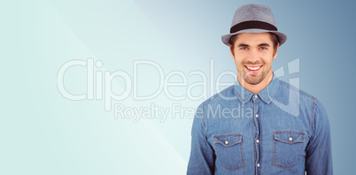 Composite image of portrait of happy hipster wearing hat