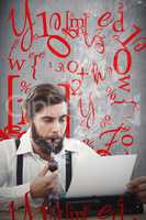 Composite image of hipster with smoking pipe working on typewrit