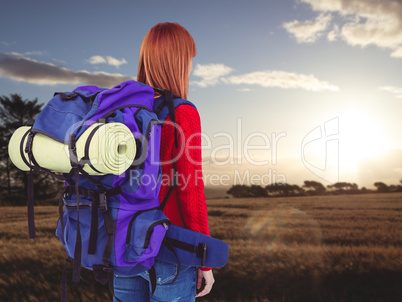 Composite image of smiling hipster woman with a travel bag