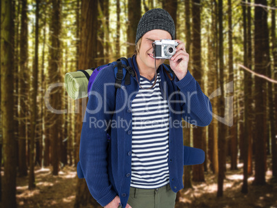 Composite image of backpacker hipster taking pictures with a ret