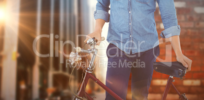 Composite image of portrait of hipster wearing knitted hat stand