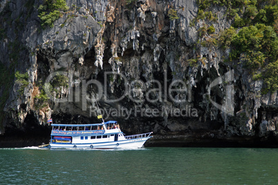 tourist ship sails along the island in Andaman Sea