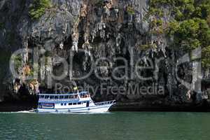 tourist ship sails along the island in Andaman Sea