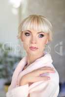 Blond beautiful woman in pink dressing gown